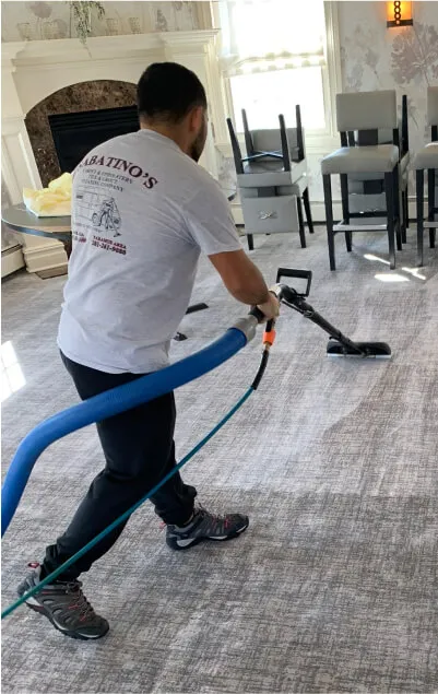 Sabatino’s technician cleaning a living room carpet